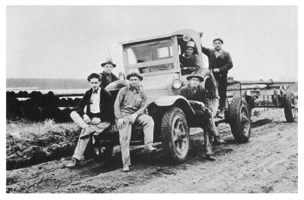 Men on vehicle in 1919